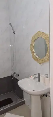 a bathroom with a sink and a mirror on the wall at Zeyden Place Apt in Praia