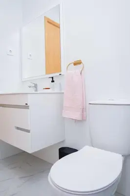 a bathroom with a toilet and a sink and a mirror at Saw Paradise in Praia T2 in Praia
