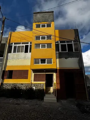 a yellow and white building with a door at Cozy Home with Terrace Views! in Ponta do Sol