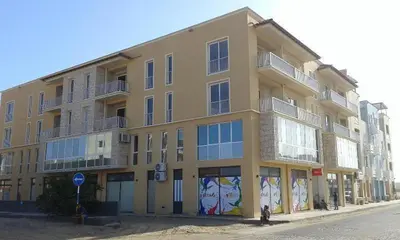 a large yellow building on the side of a street at Ideal Location in Sal Rei
