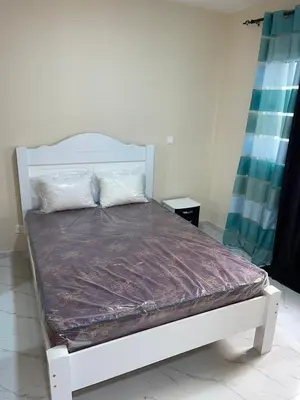a white bed in a room with a mattressvisor at madison place in Praia