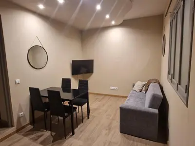 a living room with a table and a couch at Flat City Center Mindelo in Mindelo