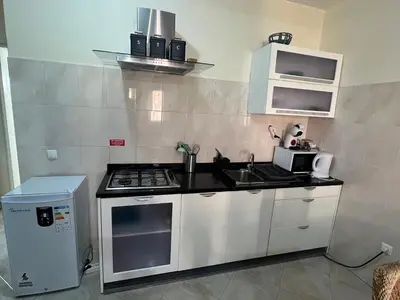 a small kitchen with a stove and a sink at Sal Breeze in Santa Maria
