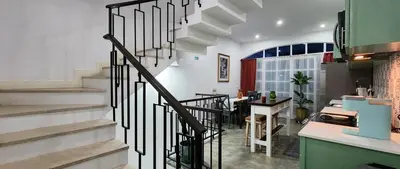 a spiral staircase in a room with a kitchen at Casinha Nova - Comfort & Class in Fogo in São Filipe