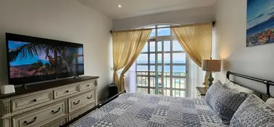 a bedroom with a bed and a television on a dresser at Casinha Nova - Comfort & Class in Fogo in São Filipe