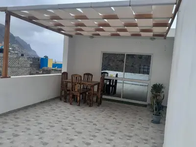 a patio with a table and chairs on a balcony at Repousando II in Ribeira Grande
