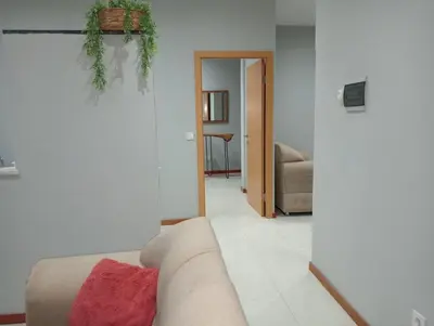 a living room with a tan couch and a living room at Niclas ApartamentoT1 in Praia