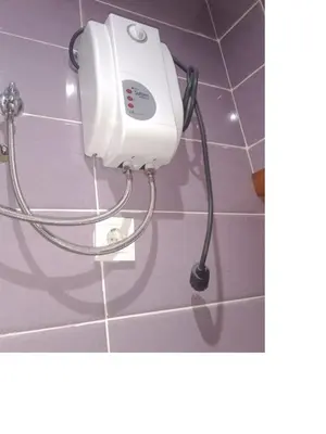 a hair dryer hanging on a wall in a bathroom at Niclas ApartamentoT1 in Praia