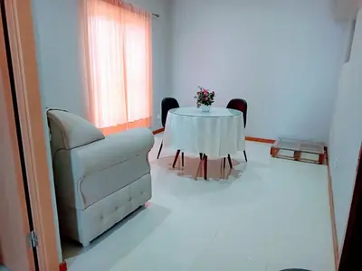 a living room with a table and a couch and a chair at Niclas ApartamentoT1 in Praia