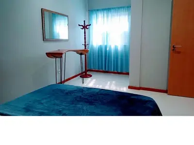 a room with a bed and a cross on the wall at Niclas ApartamentoT1 in Praia