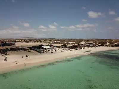 an aerial view of a beach with people and the water at Papaya Apartments Boa Vista in Sal Rei