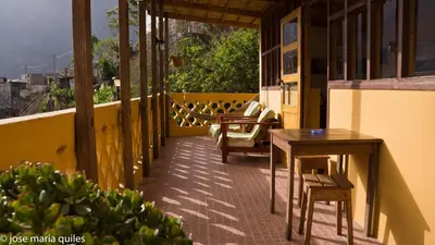 a balcony with tables and chairs on a building at Casa Cavoquinho in Paul