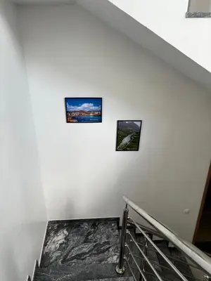 a staircase with three pictures on the wall at Pensão Gonçalves in Calheta de São Miguel