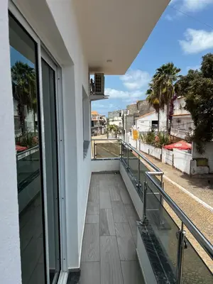a balcony of a building with a view of a street at Pensão Gonçalves in Calheta de São Miguel
