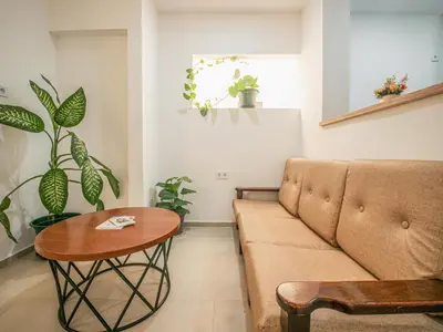 a living room with a couch and a table at Residencial LiviaMilena Santa Maria in Santa Maria