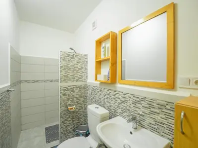 a bathroom with a toilet and a sink and a mirror at Residencial LiviaMilena Santa Maria in Santa Maria