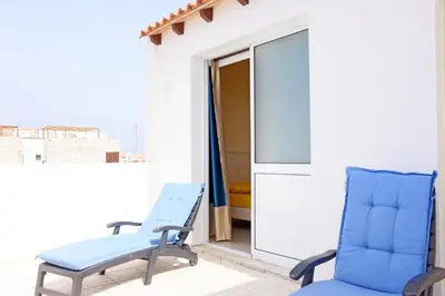 a pair of blue chairs on a balcony at Residencial LiviaMilena Santa Maria in Santa Maria