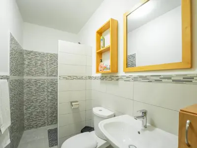 a bathroom with a toilet and a sink and a mirror at Residencial LiviaMilena Santa Maria in Santa Maria