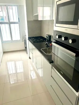 a kitchen with a stove and a microwave at Apartamento Da Costa in Mão para Trás