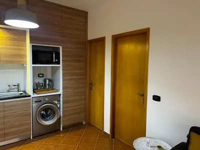 a kitchen with a washer and dryer in a room at Beira Mar AB2 in Santa Maria