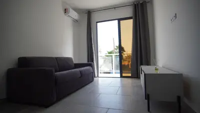 a living room with a couch and a table at Atlantico Sal Apt in Santa Maria