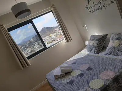 a bedroom with a bed and a large window at Morabeza Deluxe view on the sea in Mindelo