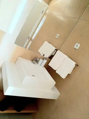 a bathroom with a white sink and a mirror at Morabeza Deluxe view on the sea in Mindelo