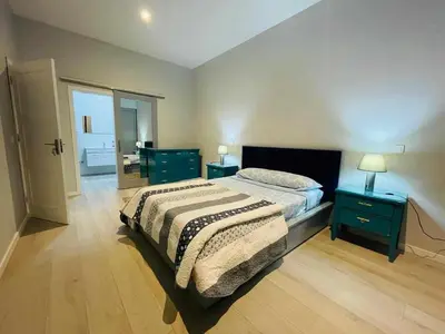 a bedroom with a bed and two night stands at Aparthotel Pilon T3 in Praia