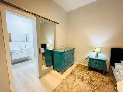 a bedroom with a green dresser and a mirror at Aparthotel Pilon T3 in Praia