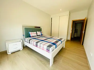 a bedroom with a bed and a night stand at Aparthotel DI LIA T3 in Praia