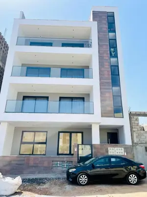 a car parked in front of a building at Aparthotel DI LIA T3 in Praia