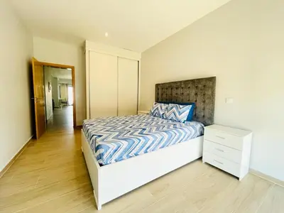 a bedroom with a bed with a blue and white comforter at Aparthotel DI LIA T3 in Praia