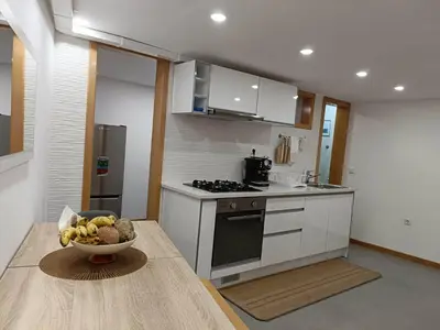 a kitchen with a bowl of fruit on a table at mezzanino Ribeira Brava in Vila da Ribeira Brava