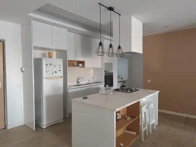 a kitchen with a white refrigerator and a counter at Isa Charme Home in Praia