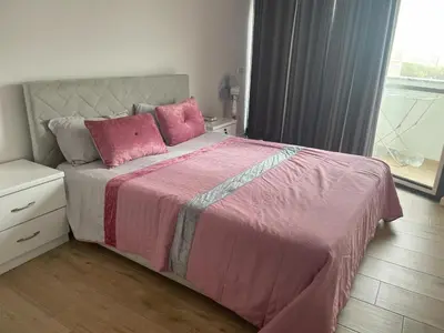 a bedroom with a pink bed with pink pillows at Isa Charme Home in Praia