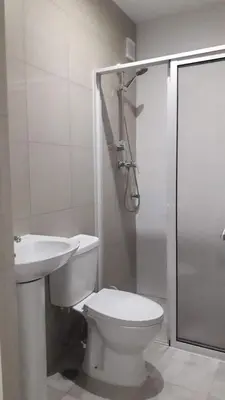 a bathroom with a toilet and a shower and a sink at CasaMrichica1 in Ribeira Grande