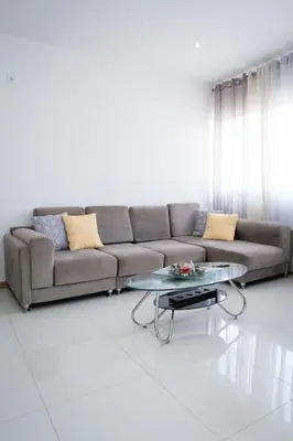 a living room with a couch and a coffee table at Apartamento das Flores 2 in Praia