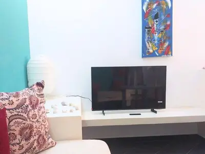 a flat screen tv sitting on a white table at Apartment in Sal Rei - Boa Vista in Sal Rei