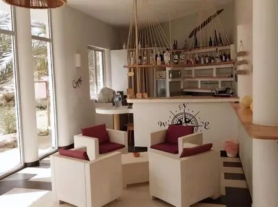 a kitchen with two white chairs and a counter at Apartment in Sal Rei - Boa Vista in Sal Rei