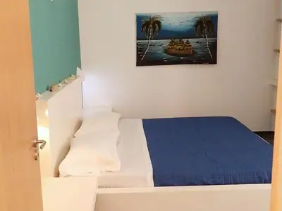 a bedroom with a bed and a painting on the wall at Apartment in Sal Rei - Boa Vista in Sal Rei