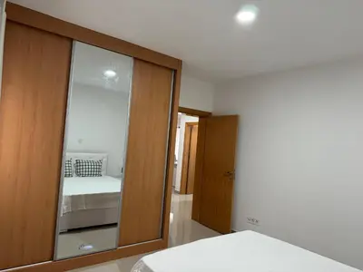 a bedroom with a mirror and a bed in it at Holiday Apartments TF in Praia