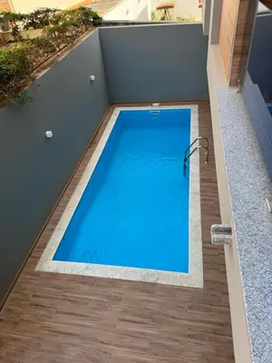 a swimming pool on the roof of a house at Holiday Apartments TF in Praia