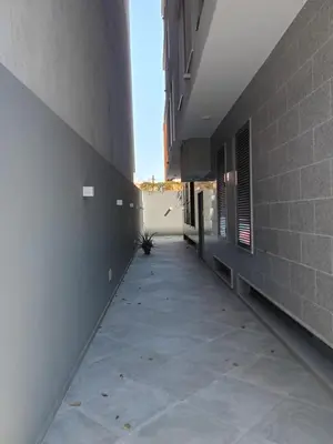 an empty hallway of a building with a sidewalk at Holiday Apartments TF in Praia