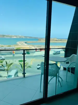 a balcony with a table and chairs and a view of a parking lot at Beramar Hotel in Praia