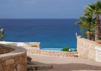 a swimming pool with the ocean in the background at Appartamento Serra. Stella Maris Exclusive in Calheta Do Maio