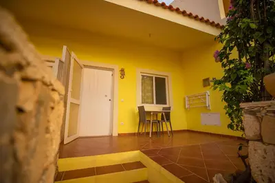 a yellow room with a table and chairs in it at Appartamento Percebes. Stella Maris Exclusive in Calheta Do Maio