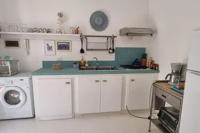 a kitchen with a sink and a washing machine at Casa Vida Boa in Sal Rei