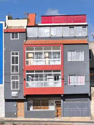 a red and gray building with a redventh floor at guesthouse emaly in Mindelo