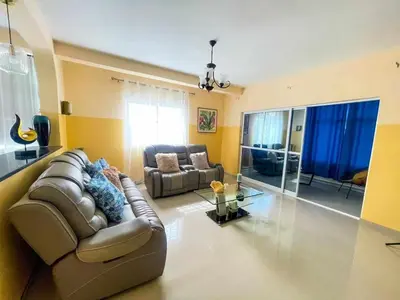 a living room with a brown leather couch and a table at Zeyden Place Apt 2 in Praia