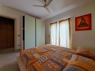 a bedroom with a bed with a quilt on it at Sal service coquero in Santa Maria